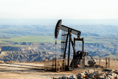 Oil pumpjack in barren landscape.